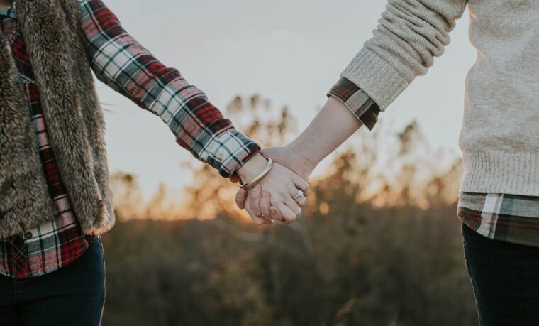 two person holding hands while standing